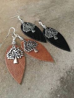 two pairs of leather earrings with tree design on the front and back, hanging from silver earwires