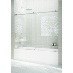 a white bath tub sitting next to a shower with glass doors on the wall and floor