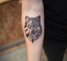 a wolf tattoo on the left forearm and right arm, with an arrow in the middle