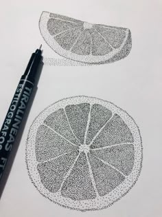 two slices of lemon sitting on top of a white paper next to a black marker