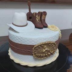 there is a cake that looks like it has boots and hats on top of it