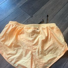 Color Light Orange Size L Never Worn Nike Beachwear Bottoms For Beach Season, Athleisure Athletic Shorts For Beach In Spring, Spring Beach Athleisure Athletic Shorts, Nike Summer Bottoms For Vacation, Nike Beach Bottoms For Beach Season, Nike Stretch Athletic Shorts For Beach, Nike Summer Vacation Bottoms, Nike Athletic Shorts With Elastic Waistband For Beach, Nike Athleisure Athletic Shorts For Beach