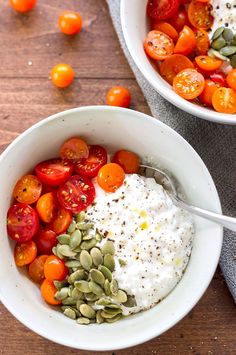 two bowls filled with different types of food on top of a wooden table next to each other