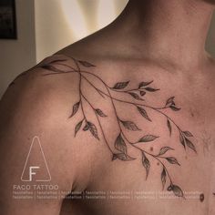 a man's chest with leaves on it and the word fasci tatoo