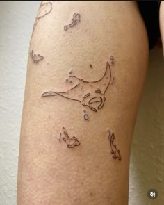 a woman's leg with tattoos on it that has fish and bubbles in the water