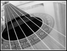 an acoustic guitar is shown in black and white