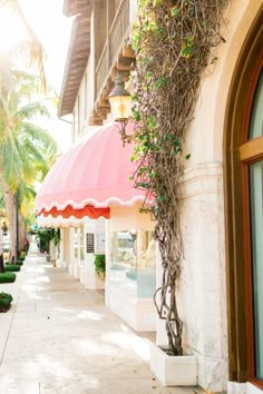 a pink and white awning on the side of a building