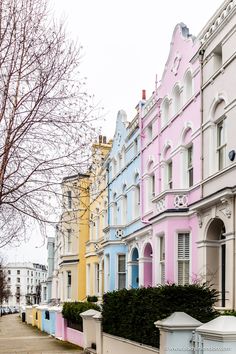 a row of pastel colored houses line the street