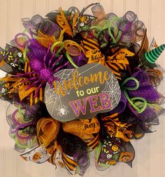 a halloween wreath that says welcome to our web