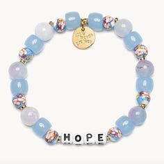 a bracelet that says hope on it with beads and charms around the beaded ends