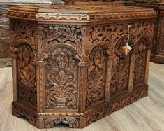 an ornate carved wooden box on the floor