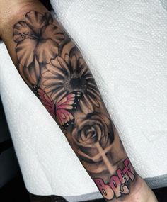 a person with a cross and flowers on their arm