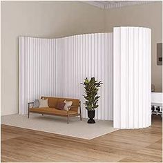 a living room with white vertical blinds on the wall and a couch next to it