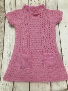 Hand Knitted dress designed to fit 3-4 year old. Measurements are 18 inch approx in length and has a 20 inch approx chest. Short sleeve so great for spring wear. Small little pockets in the front too. Pink Girls Dress, Hand Knitted Dress, Girls Pink Dress, Spring Wear, Knitted Dress, Girls Dress, Spring Dresses, Pink Girl, Cable Knit