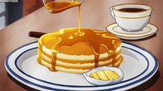 pancakes with syrup being poured onto them on a plate next to a cup of coffee