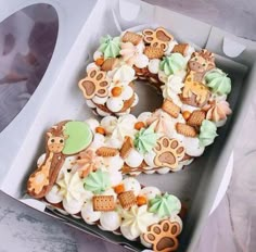 a box filled with lots of decorated cookies