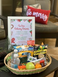 a basket filled with snacks and drinks on top of a table next to a sign