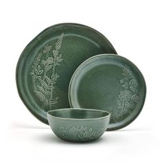 green dinnerware set with floral designs on the front and side dishes in the back