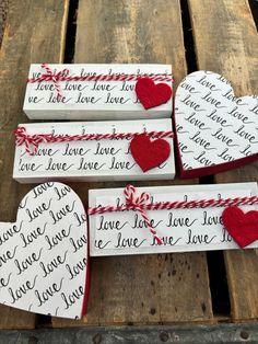 three valentine's day gift boxes with love written on them and hearts tied in twine