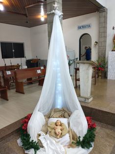 a bed with a white canopy over it in a church