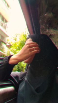 a person's hand on the back seat of a car