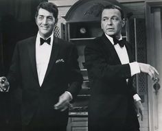 two men in tuxedos standing next to each other