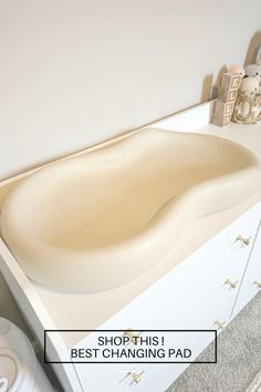 a bathroom sink with the words shop this best changing pad