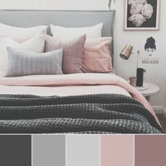 a bed with pink and grey pillows on top of it in a bedroom color scheme