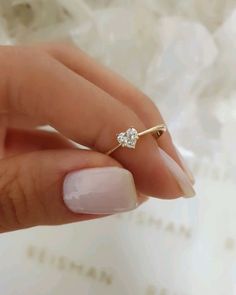 a close up of a person's hand with a ring on their finger and a diamond in the middle