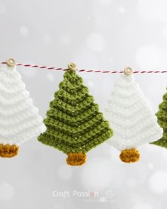 three crocheted christmas trees hanging on a line