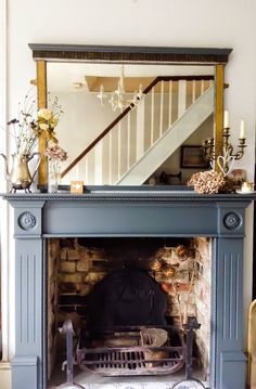 a fireplace with a mirror above it