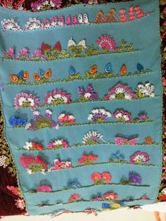 a blue quilt with flowers and butterflies on it