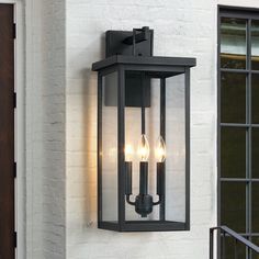 Illuminate your front door or garage with this contemporary candle style exterior wall mounted lantern sconce light. This wall lamp is rated for wet locations. Its well-constructed sturdy frames are made from metal in a powder-coated black finish, plus the 4 clear glass panels with a elongated shape enclosed in a black and sleek/elegant framework, which complements your decor from classic to rustic, ideal for Front Porch, Patio, Garage, Deck etc. Plus, it's compatible with a dimmer switch, so yo Garage Door Lanterns, Exterior Entry Lighting, Black Exterior Lights, Exterior Porch Lights, Lantern Lighting, Exterior Lights, Porch Lights, Exterior Light Fixtures, Black Outdoor Wall Lights