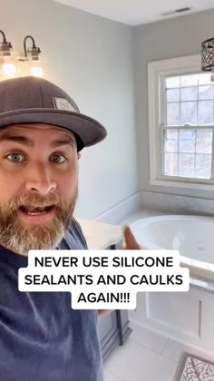 a man wearing a hat in front of a bathtub with the caption never use siloone sealants and caulks again again