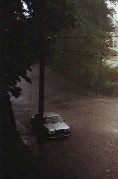 a car is parked in the middle of a flooded street