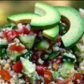 a salad with cucumbers, tomatoes and other veggies