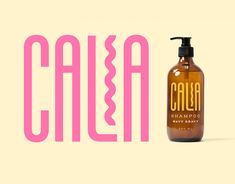 a bottle of soap sitting next to a pink and white sign that says calea