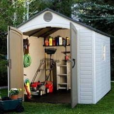 a storage shed with the door open and tools in it