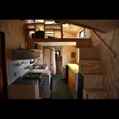 the interior of a tiny house with stairs