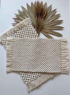 three pieces of woven fabric with leaves on top