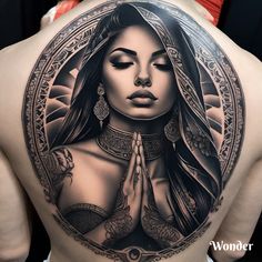 the back of a woman's body with an intricate tattoo design on her shoulder