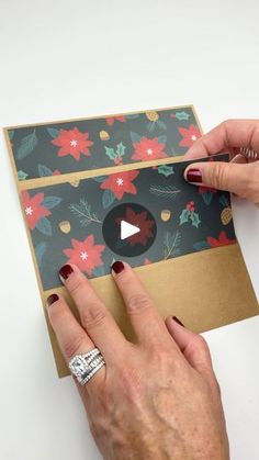 a woman is cutting out a christmas card with scissors