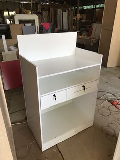 a white cabinet with drawers in a room