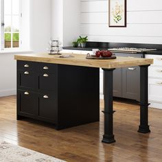 a kitchen island with two drawers and an open drawer on the side, in front of a window