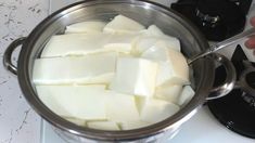 cubed cheese being cooked in a pot on the stove