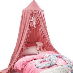 a bed with a pink canopy over it in a girls's room or bedroom