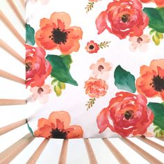 an orange and pink flower print on white fabric