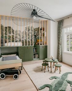 a bedroom with green furniture and decor in the room, including a bed that's on top of a wooden platform