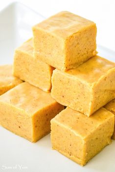 several squares of yellow cake sitting on top of a white plate