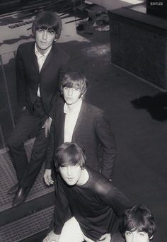 the beatles posing for a black and white photo